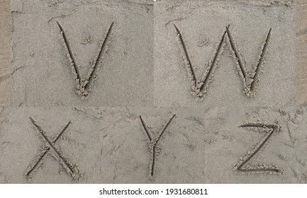 character V W X Y Z hand written on sand in evening