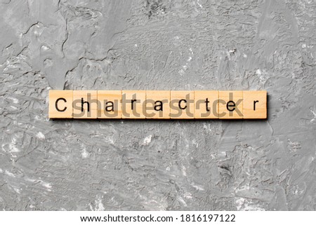 CHARACTER word written on wood block. CHARACTER text on cement table for your desing, concept.