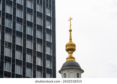 A characteristic architectural solution to harmonize the building of a modern style and the traditional style of the church. The concept of the relationship between old and new.