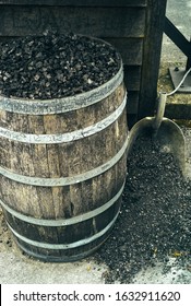 Charcoal in a Barrel and a Shovel, used for Mellowing Tennessee Whiskey by Filtration - Shutterstock ID 1632911620