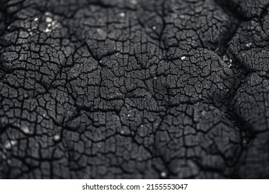 charcoal black carbon grunge crack from burn wood and old tire rubber material texture pattern
