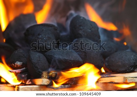 Charcoal briquettes firing up for the grill