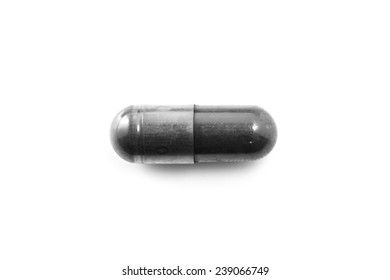 Charcoal capsules isolated on white