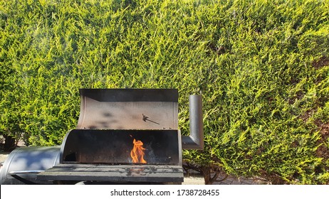 Charcoal Oil Drum Style Bbq Flames In A Summery English Back Garden