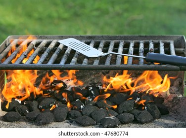 Charcoal On Fire Heating Up A Barbecue Pit Before Cooking