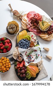  Charcuterie  assortment boards, cheeses, berroes and fruits on a white wooden background. - Shutterstock ID 1679994178
