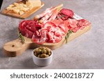 Charcuterie board. Antipasti appetizers of meat platter with salami, prosciutto crudo or jamon and olives.