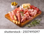 Charcuterie board. Antipasti appetizers of meat platter with salami, prosciutto crudo or jamon and olives.