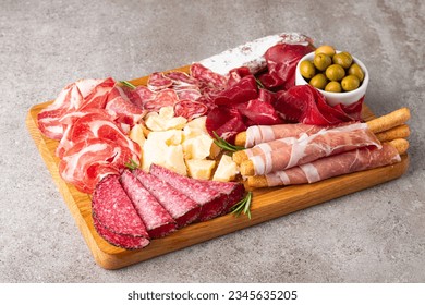 Charcuterie board. Antipasti appetizers of meat and cheese platter with salami, prosciutto crudo or jamon and olives - Powered by Shutterstock