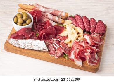 Charcuterie board. Antipasti appetizers of meat and cheese platter with salami, prosciutto crudo or jamon and olives
