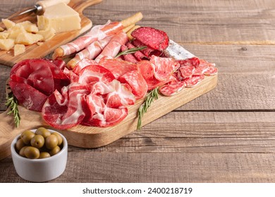 Charcuterie board. Antipasti appetizers of meat platter with salami, prosciutto crudo or jamon and olives. - Powered by Shutterstock