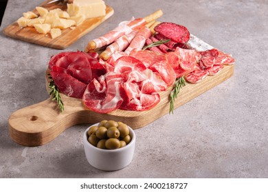 Charcuterie board. Antipasti appetizers of meat platter with salami, prosciutto crudo or jamon and olives. - Powered by Shutterstock