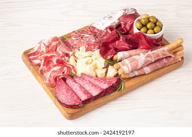 Charcuterie board. Antipasti appetizers of meat and cheese platter with salami, prosciutto crudo or jamon and olives - Powered by Shutterstock