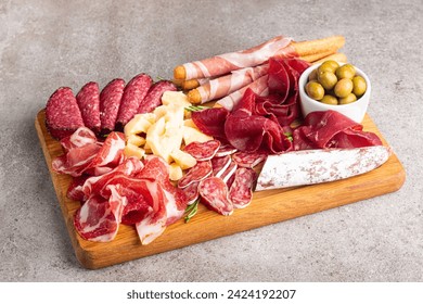 Charcuterie board. Antipasti appetizers of meat and cheese platter with salami, prosciutto crudo or jamon and olives - Powered by Shutterstock