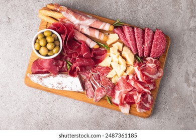 Charcuterie board. Antipasti appetizers of meat and cheese platter with salami, prosciutto crudo or jamon and olives - Powered by Shutterstock