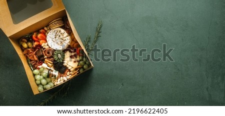 Charcuterie Board in a Box with fresh fruits, meats, and cheese.