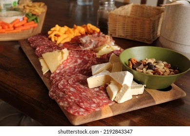 Charcuterie Board With Meat, Cheese, Nuts, Seeds, On Wooden Platter And Table