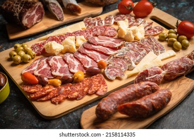 Charcuterie board with various cured meats and sausages - Shutterstock ID 2158114335