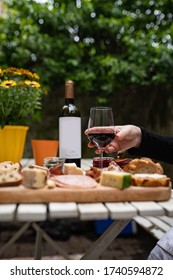 Charcuterie Spread With Wine On An Outdoor Picnic/patio Table