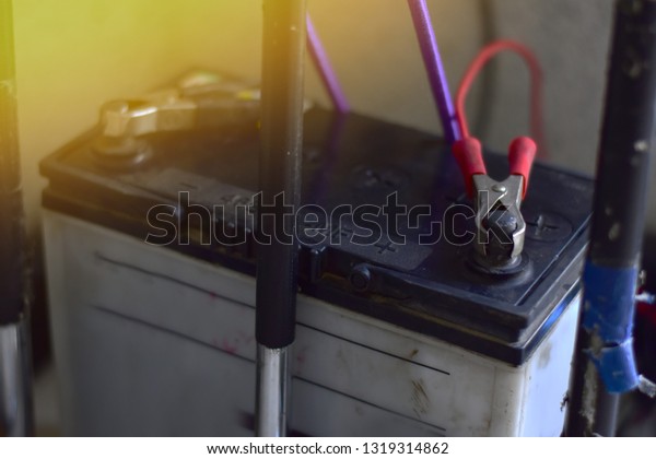 Charge the\
device with a car battery. selective\
focus