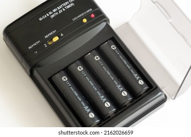 Charge and discharge adapter of Nickel Cadmium and Nickel Magnesium batteries. 1.2 Volt and 2450 milliamp AA batteries are charging. - Shutterstock ID 2162026659