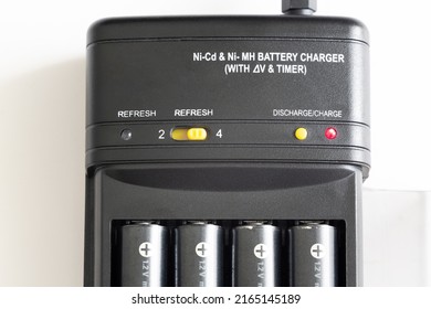 Charge And Discharge Adapter Of Nickel Cadmium And Nickel Magnesium Batteries. AA Batteries Are Charging.