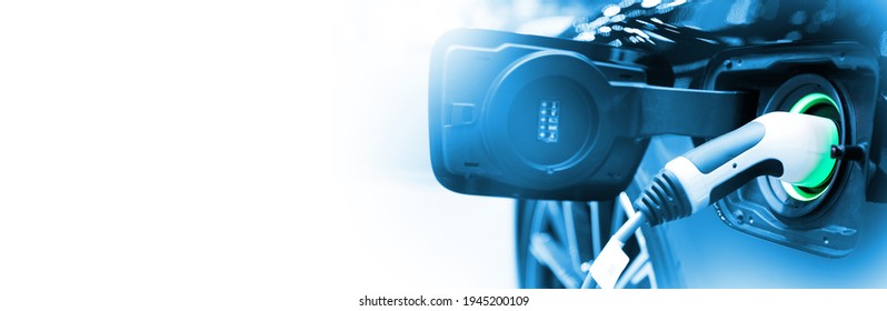Charge EV car vehicle electric battery on station with blue car on panoramic banner white background with copy space. Idea for friendly environment nature electric energy technology green eco concept. - Shutterstock ID 1945200109