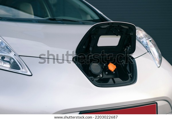 Charge port\
on an electric car. Socket for fast charging. \
Eco friendly\
alternative energy green environment\
concept.