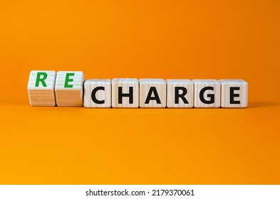 Charge Or Recharge Symbol. Turned Cubes And Changed The Word 'charge' To 'recharge'. Beautiful Orange Table, Orange Background. Business Charge Or Recharge Concept. Copy Space.