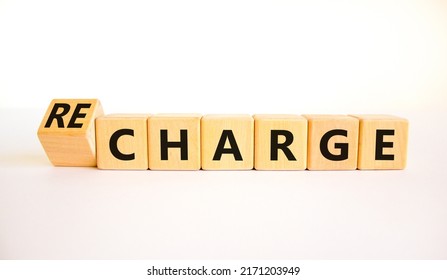 Charge Or Recharge Symbol. Turned Wooden Cubes And Changed The Word Charge To Recharge. Beautiful White Table White Background. Business Charge Or Recharge Concept. Copy Space.