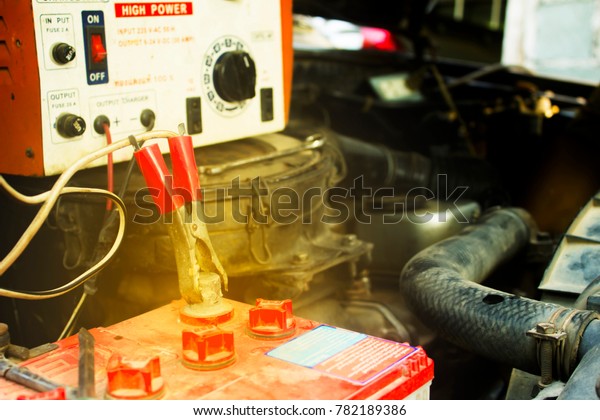 Chargeing old car battery from the old charger\
with copy space.