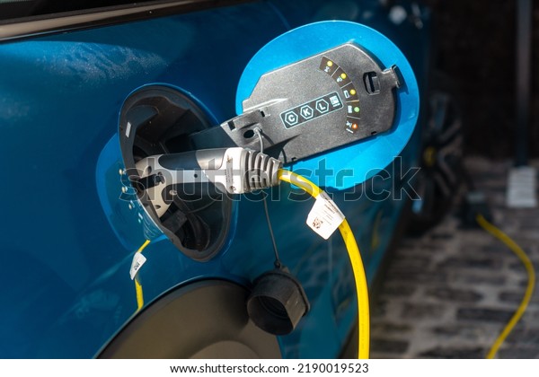 Charger of an electric car charging\
the batteries in the garage of the house, not\
gasoline