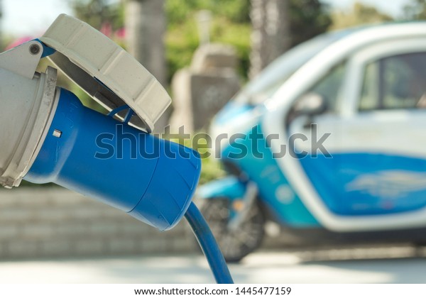 Charger for environmentally\
friendly car with electric motor. Electric mobility in the\
city.