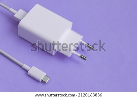 Charger and USB cable type C over blue background