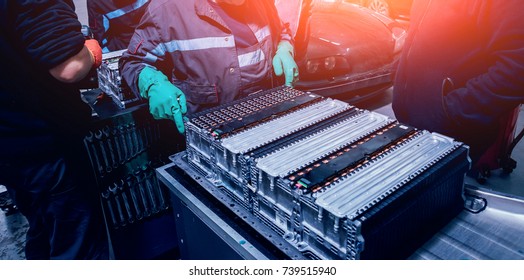 Charging The Batteries Of The Elecric Motor. Disassembling The Battery Of An Electric Vehicle Engine. Car Service