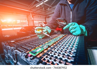 Charging The Batteries Of The Elecric Motor. Disassembling The Battery Of An Electric Vehicle Engine. Car Service