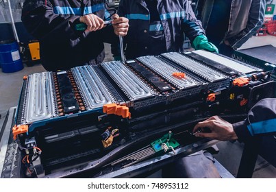 Charging The Batteries Of The Elecric Motor. Disassembling The Battery Of An Electric Vehicle Engine. Car Service