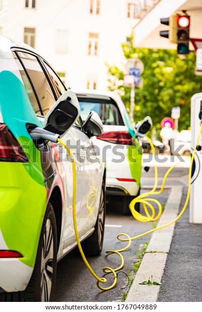 Charging battery of an electric car in city.\
Closup of cable.