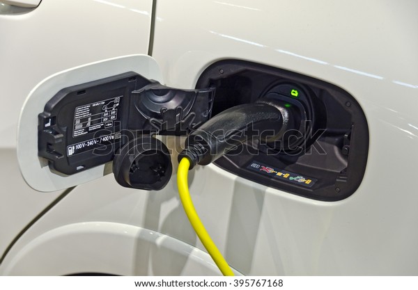 charging cable at the tail of a modern electric\
driven car