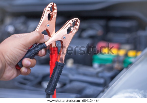 Charging car battery with
electricity trough jumper cables with copper clamps attached for
start engine car , An incident when we forget check or
maintenance
