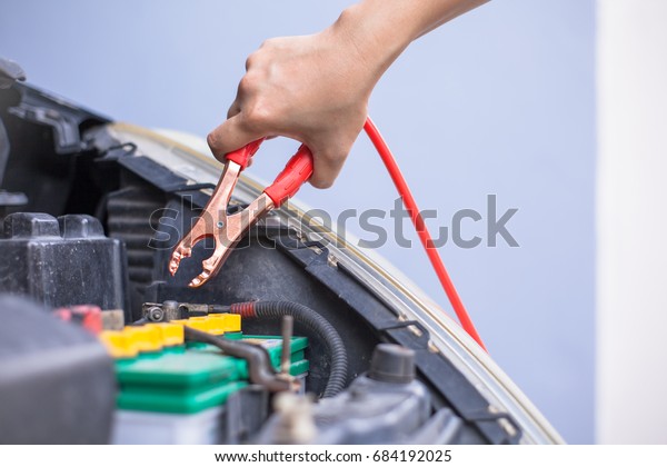 Charging car battery with\
electricity trough jumper cables with copper clamps attached for\
start engine car , An incident when we forget check or\
maintenance\
