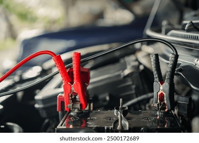 Charging the car battery with a jumper cable for cars with dead batteries, Repair and maintenance concept - Powered by Shutterstock