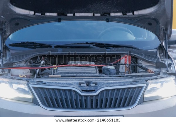 Charging a car battery in\
winter. Help on the road. Close-up. Connecting high voltage wires\
to the car battery. Resuscitation of the car in severe winter\
conditions