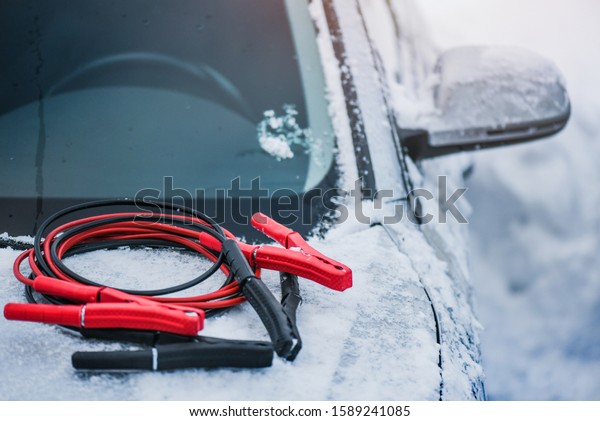 Charging cars battery with electricity trough electric\
cables. Vehicle jumper cable on car need starting or connection in\
winter time. 