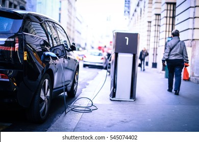 Charging Electric Car On The Street