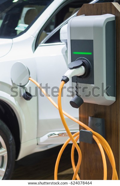 Charging an electric car with the power cable supply\
plugged in