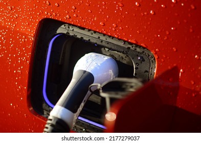 Charging Electric Car In The Rain