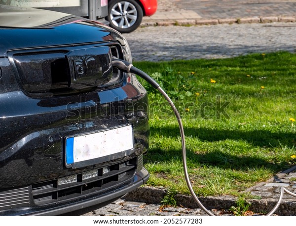 Charging an\
electric car at the charging\
station