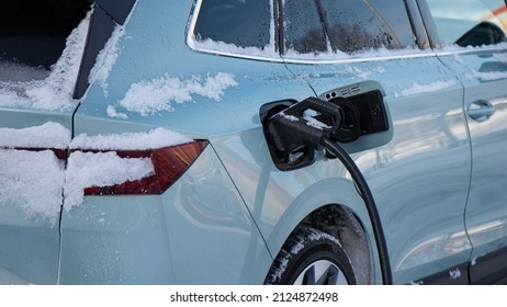 Charging An Electric Car In Winter.