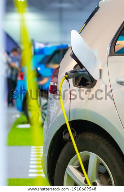 Charging an electric or hybrid PHEV car with the\
power cable supply plugged in. Electric car charging station.\
Prague, Czechia, November\
2019.
